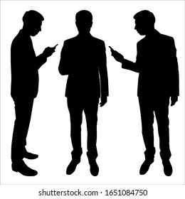 Businessman in a suit is standing with a phone in his hands. Modern lifestyle. Group of people with smart phones. Black flat vector illustration with male silhouette on a white isolated background.