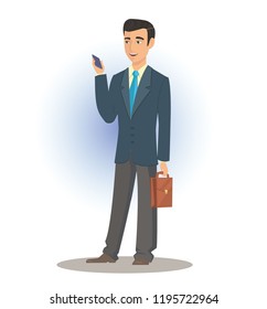 Businessman in a suit stands with a phone in his other hand portfolio.