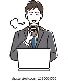Businessman taking a coffee break in front of a computer