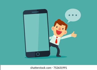 Businessman talking beside big smart phone with blank screen. Business communication concept.