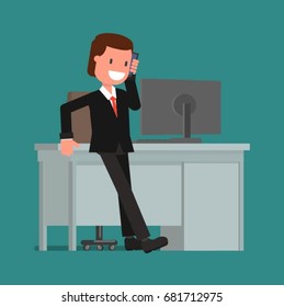 Businessman talking on the phone while sitting at the computer