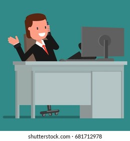 Businessman talking on the phone while sitting at the computer
