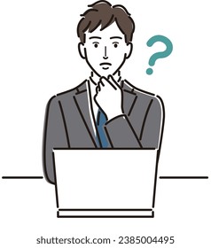 Businessman thinking in front of a laptop