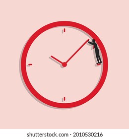Empresario intenta hacer retroceder el tiempo. El hombre se pone de pie en la cara del reloj y empuja hacia atrás la mano del reloj. Concepto de plazo de negocios.