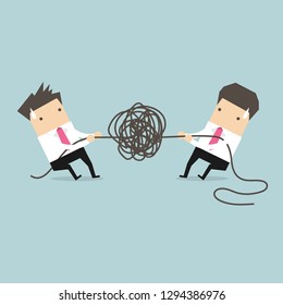 Businessman trying to unravel tangled rope or cable.