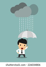 Businessman under an umbrella in the rain. 