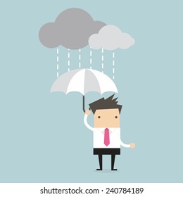 Businessman under an umbrella in the rain