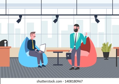 businessman using laptop and talking with his business partner businesspeople discussing new project communication teamwork concept creative office interior flat full length horizontal