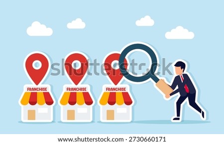 Businessman using magnifying glass to analyze franchise outlets with location pins monitoring franchise business performance