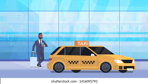 businessman using mobile app ordering taxi on street african american business man in formal wear with luggage near yellow cab city transportation service concept full length flat horizontal