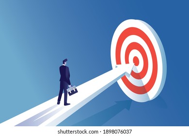 businessman walk in path of arrow to target board for gain success in business