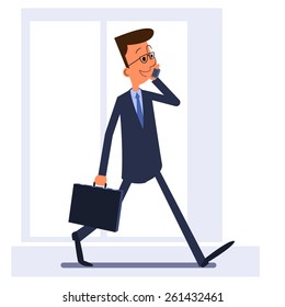 Businessman walking, holding briefcase and talking on the phone