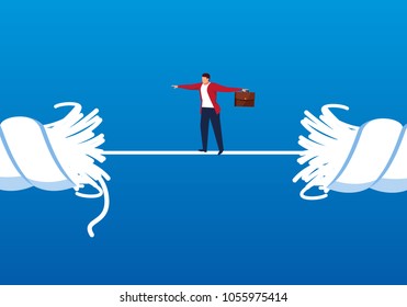 Businessman walking on a rope that is about to break