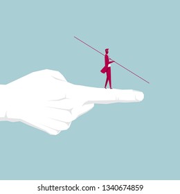 Businessman walking tightrope on the finger. Isolated on blue background.