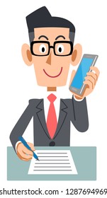 A businessman wearing glasses who takes notes while calling