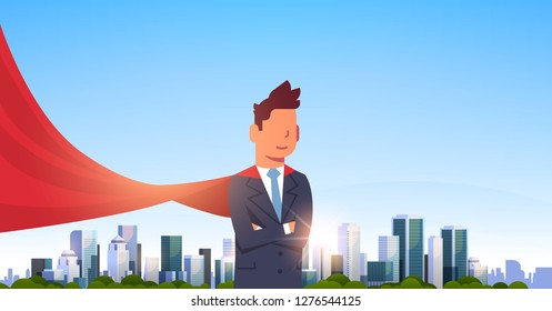 businessman wearing red super hero cape representing business power and courage leadership success concept over big modern city skyscraper cityscape skyline flat horizontal