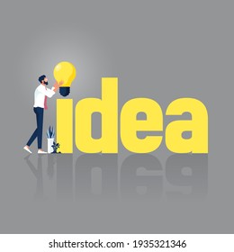 Businessman with word Idea. Concept of creating and building idea