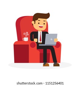 Businessman working from home with laptop sitting in cozy armchair with a cup of coffee
