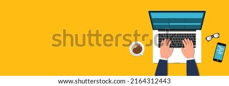Businessman working at the home office. New normal lifestyle. Social distancing concept. Top view of people working with computers at the work desk. Desk with a laptop, coffee, glasses, and mobile
