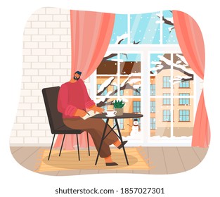 Businessman working at home at a table near window with winter cityscape view. Big boss or freelancer. Busy man talking on phone holding smartphone with shoulder and writes information to notebook