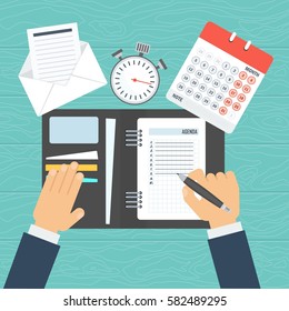 Businessman writes a daily routine. 