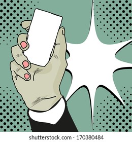 Businessman's hand holding blank paper business card or silhouette of mobile phone in pop art style comics book. Closeup isolated on white background 