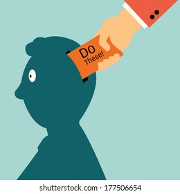 Businessman's hand putting paper with message ' do these' into man's head, business concept in control people. You can write and change for your own message. 