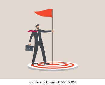 Businessmen or entrepreneurs stick the flagpole right on the target, achieving business targets.