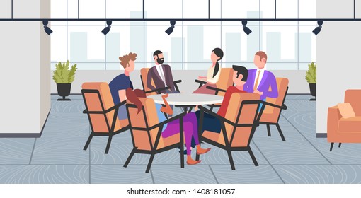 businesspeople group discussing new project during conference meeting sitting at round table brainstorming colleagues planning startup business time concept modern co-working office interior full