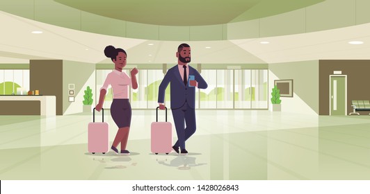 businesspeople with luggage couple standing at reception area african american business man woman holding suitcase contemporary lobby hotel hall interior flat horizontal full length