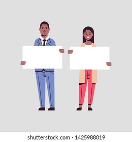 businesspeople man woman holding empty blank signboard business partners african american couple showing blank white cardboard advertisement concept flat full length