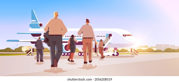 businesspeople near airplane standing back to camera rear view of business people group boarding into plane