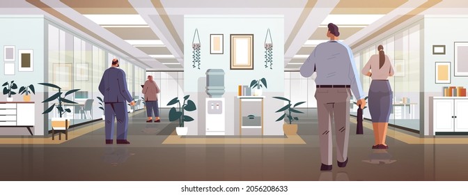 businesspeople standing back to camera rear view of business people group in office corridor