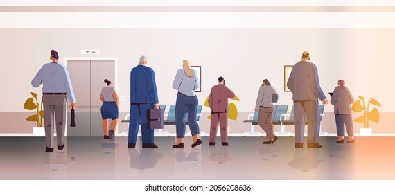 businesspeople standing back to camera rear view of business people group in office corridor