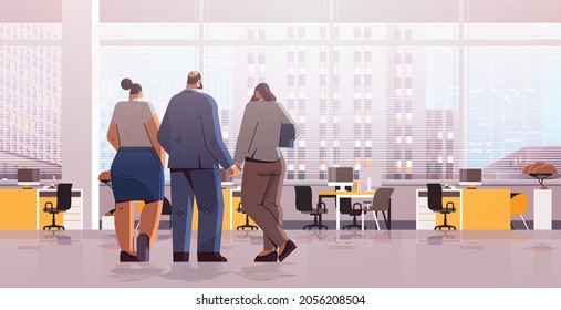 businesspeople team standing back to camera rear view of elegant business people discussing during meeting in office