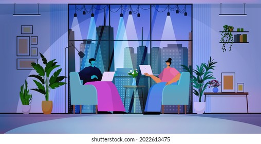 businesspeople using laptops business people working in modern dark night office horizontal