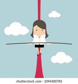 Businesswoman balancing on rope in the air.