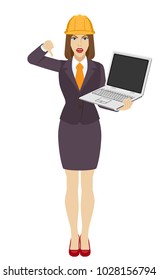 Businesswoman in construction helmet  holding a laptop notebook and showing thumb down gesture as rejection symbol. Full length portrait of businesswoman in a flat style. Vector illustration.