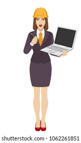 Businesswoman in construction helmet  holding a laptop notebook and giving pen or stylus for your electronic signature. Full length portrait of businesswoman in a flat style. Vector illustration.