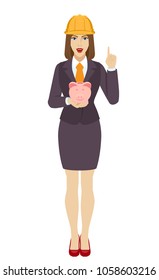 Businesswoman in construction helmet with piggy bank pointing up. Full length portrait of businesswoman in a flat style. Vector illustration.