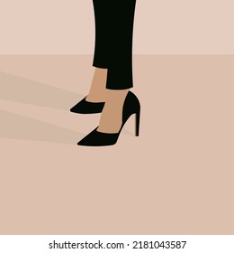 A businesswoman dressed in black pants and high-heeled shoes. 