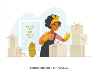 A businesswoman in her closed shop packs products for delivery. Small business during the quarantine. Trading and pandemic. Service for customers. A shop is open for delivery only. 