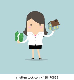 Businesswoman holding house and money
