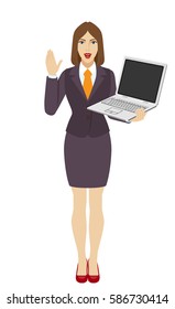 Businesswoman holding a laptop notebook and greeting someone with his hand raised up. Full length portrait of businesswoman in a flat style. Vector illustration.