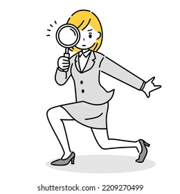 Businesswoman holding a magnifying glass.