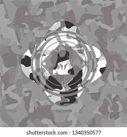 businesswoman icon inside grey camouflage emblem