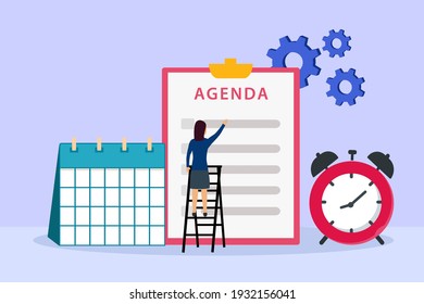 Businesswoman looking at agenda list on the clipboard with calendar and alarm clock