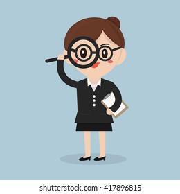 Businesswoman looking through a magnifying glass