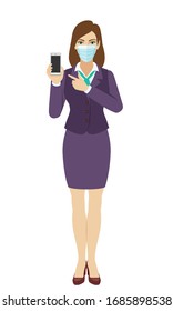 Businesswoman with medical mask pointing at a mobile phone. Full length portrait of businesswoman in a flat style. Vector illustration.