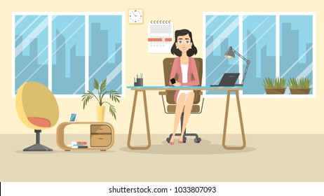 Businesswoman at office sitting at desk and smiling.